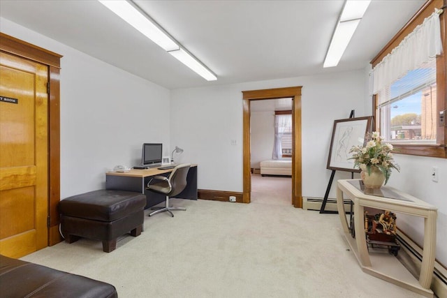 home office featuring light colored carpet, plenty of natural light, and a baseboard heating unit