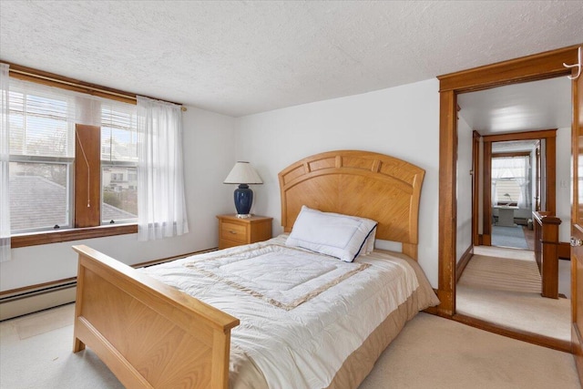 bedroom with light colored carpet, a textured ceiling, and baseboard heating