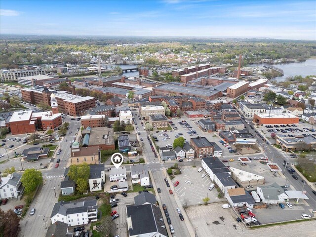 view of property location with a nearby body of water and nearby urban area