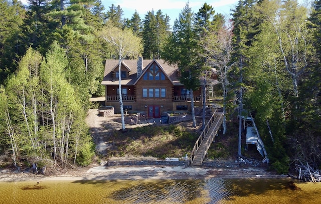 869 Turkey Tail Rd Unit T4, Indian Purchase Twp, ME 04462 - rear view of house featuring a chimney, log siding, and stairway