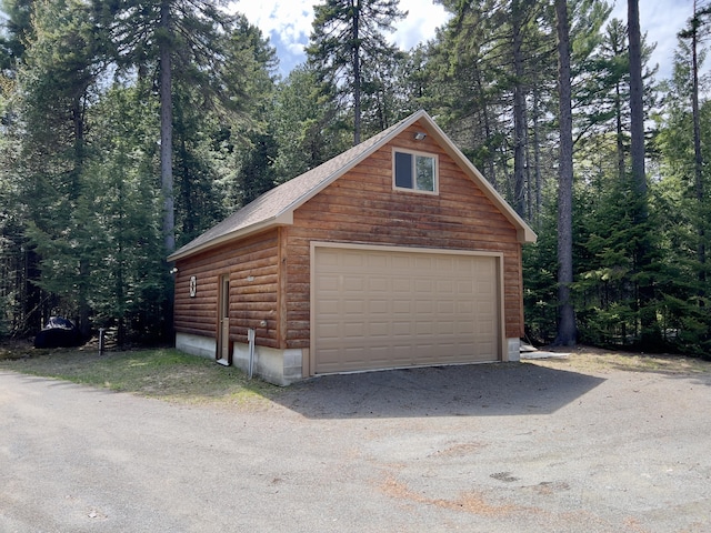 869 Turkey Tail Rd Unit T4, Indian Purchase Twp, ME 04462 - detached garage featuring a wooded view