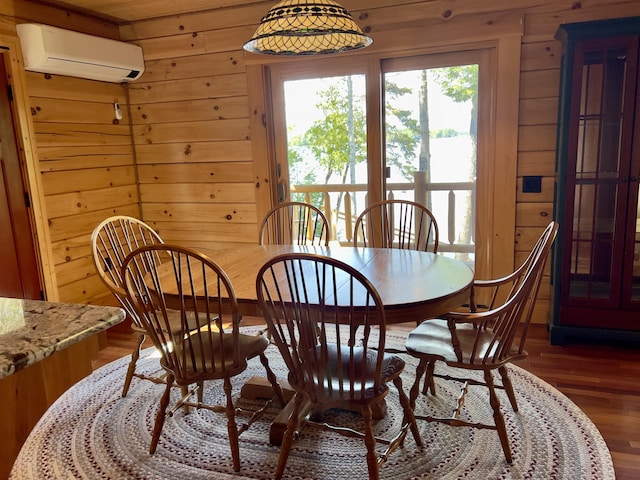 869 Turkey Tail Rd Unit T4, Indian Purchase Twp, ME 04462 - dining area with a wall mounted AC, wooden walls, and wood finished floors