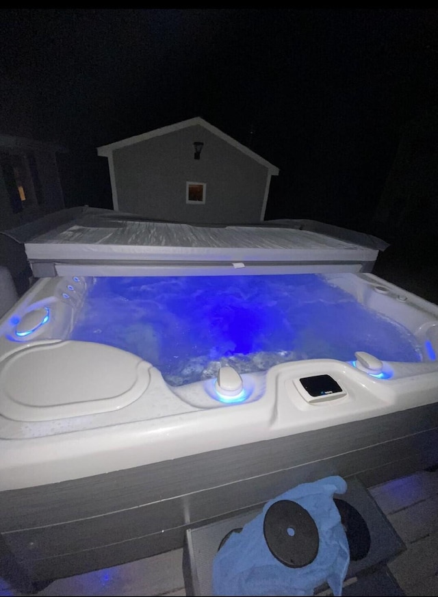 1824 Sunny Cove Ln, Meddybemps, ME 04657 - pool at night featuring a hot tub
