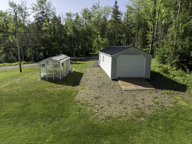 1824 Sunny Cove Ln, Meddybemps, ME 04657 - detached garage featuring a view of trees