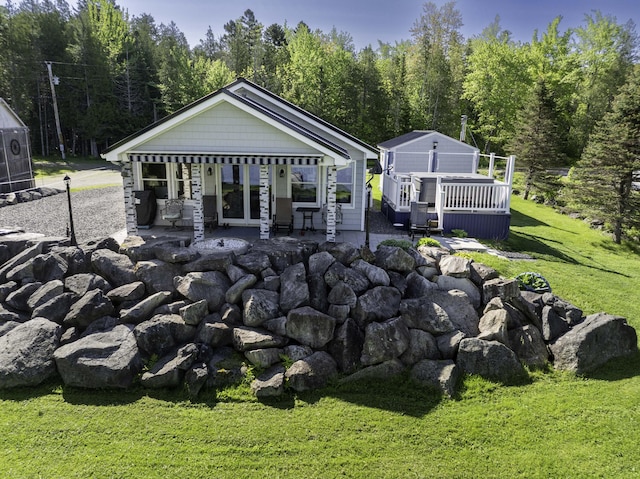 1824 Sunny Cove Ln, Meddybemps, ME 04657 - back of house featuring a yard, a patio area, a wooden deck, and a view of trees