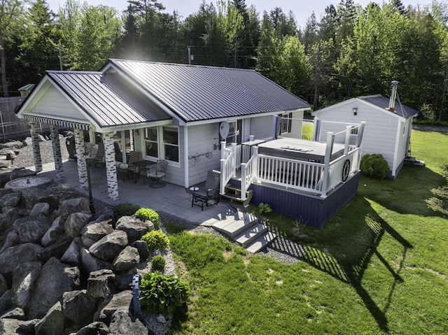 1824 Sunny Cove Ln, Meddybemps, ME 04657 - rear view of property with a patio, a yard, a wooden deck, a standing seam roof, and metal roof