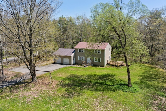 430 Old Bath Rd, Wiscasset, ME 04578 - colonial house with an attached garage, asphalt driveway, a front lawn, and metal roof