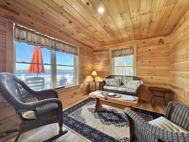 53 Pigeon Rd, Fletchers Landing Twp, ME 04605 - living area featuring wood walls, wood ceiling, a water view, and wood finished floors