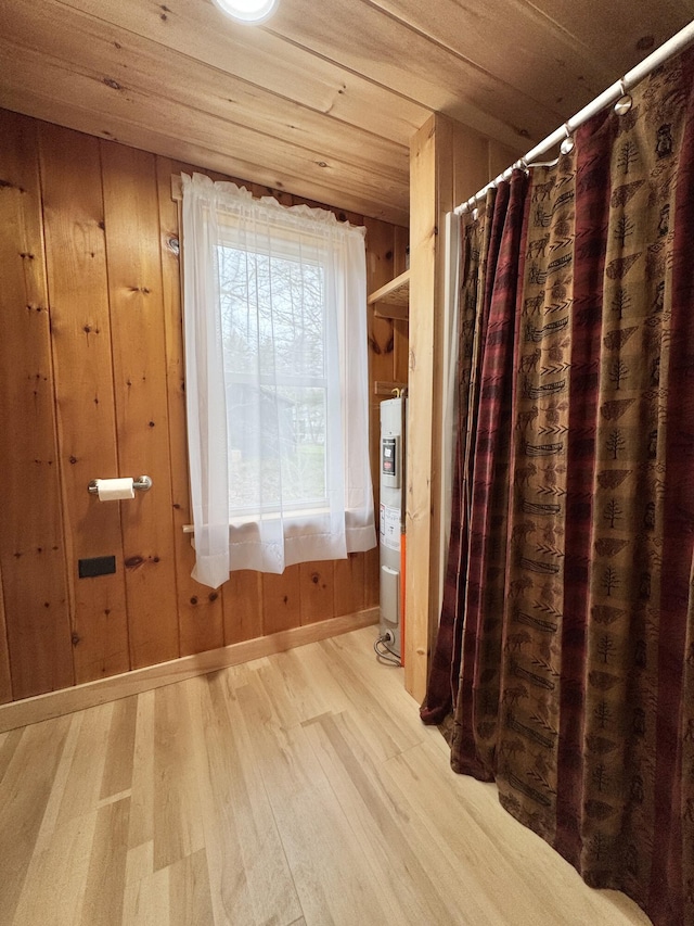 53 Pigeon Rd, Fletchers Landing Twp, ME 04605 - bathroom featuring wood finished floors, a shower with curtain, and wood walls