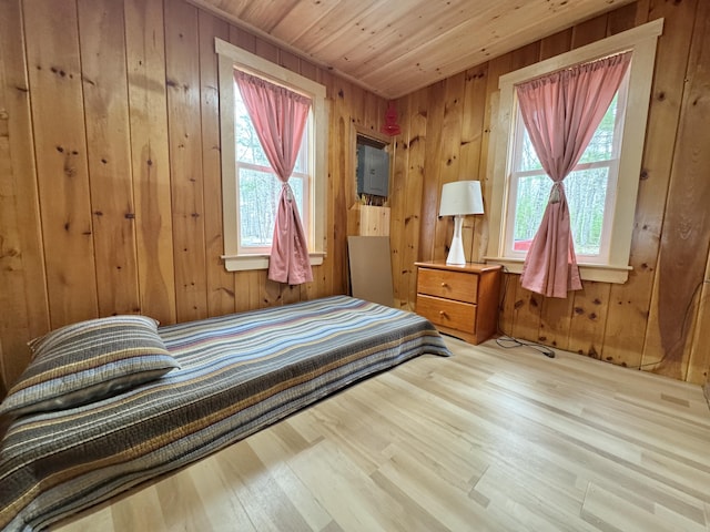 53 Pigeon Rd, Fletchers Landing Twp, ME 04605 - bedroom with multiple windows, wooden walls, wood finished floors, and wood ceiling