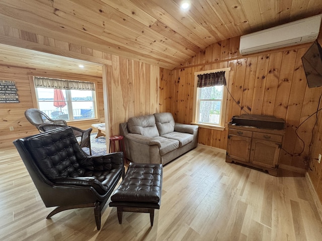 53 Pigeon Rd, Fletchers Landing Twp, ME 04605 - sitting room with vaulted ceiling, a wall unit AC, light wood-style floors, wood walls, and wood ceiling
