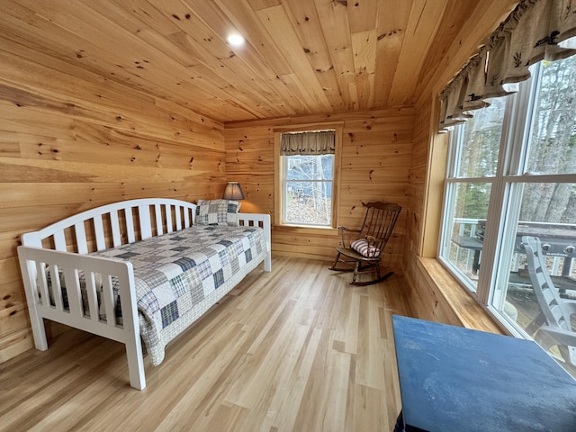 53 Pigeon Rd, Fletchers Landing Twp, ME 04605 - bedroom with wood ceiling, wooden walls, and wood finished floors