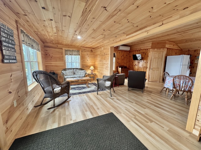 53 Pigeon Rd, Fletchers Landing Twp, ME 04605 - living area featuring a wall unit AC, wooden walls, wood finished floors, and wooden ceiling