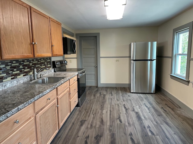 72 Seal Cove Rd, Southwest Harbor, ME 04679 - kitchen featuring appliances with stainless steel finishes, a sink, dark wood-style floors, backsplash, and baseboards