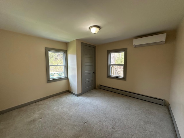 72 Seal Cove Rd, Southwest Harbor, ME 04679 - unfurnished bedroom featuring a wall unit AC, a baseboard radiator, carpet flooring, and baseboards