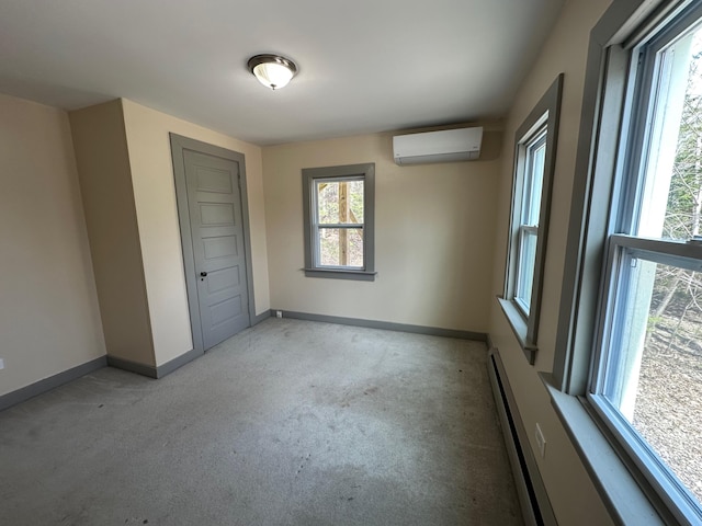 72 Seal Cove Rd, Southwest Harbor, ME 04679 - unfurnished bedroom featuring an AC wall unit, baseboards, light carpet, and a baseboard heating unit