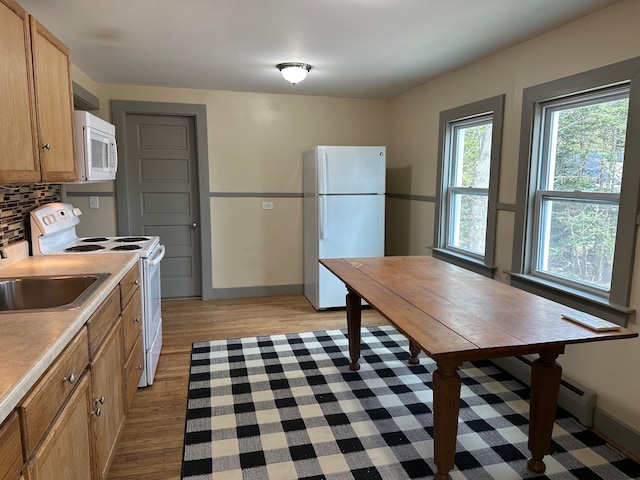 72 Seal Cove Rd, Southwest Harbor, ME 04679 - kitchen with white appliances, light wood-style flooring, decorative backsplash, light countertops, and baseboards