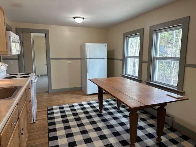 72 Seal Cove Rd, Southwest Harbor, ME 04679 - kitchen featuring white appliances, light wood-style flooring, light countertops, baseboard heating, and baseboards