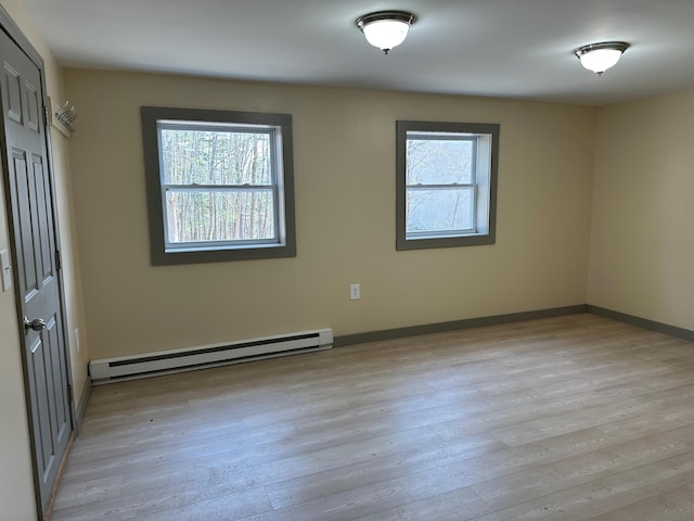 72 Seal Cove Rd, Southwest Harbor, ME 04679 - unfurnished room featuring baseboard heating, plenty of natural light, and light wood-style flooring