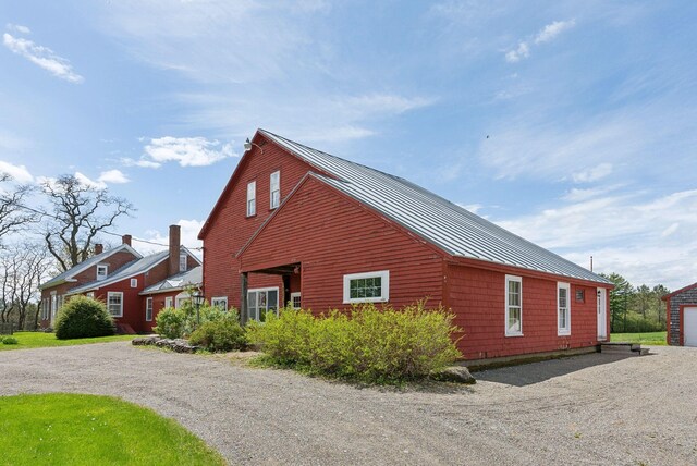 538 Malbons Mills Rd, Skowhegan, ME 04976 - view of property exterior with a standing seam roof, metal roof, and gravel driveway