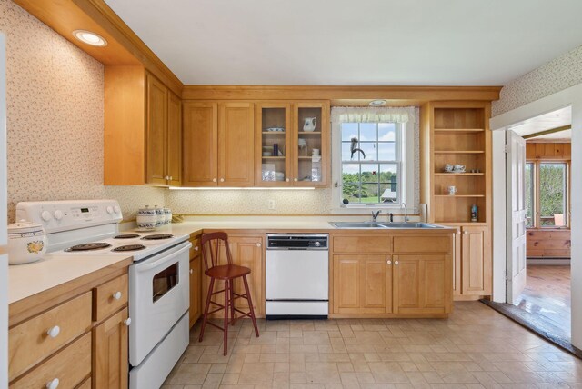 538 Malbons Mills Rd, Skowhegan, ME 04976 - kitchen with white appliances, a sink, wallpapered walls, light countertops, and glass insert cabinets
