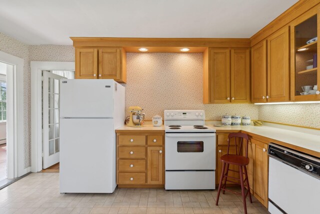538 Malbons Mills Rd, Skowhegan, ME 04976 - kitchen featuring white appliances, wallpapered walls, light countertops, brown cabinets, and glass insert cabinets