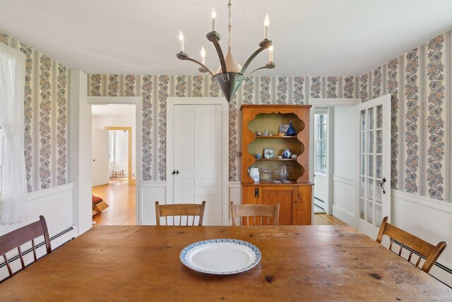 538 Malbons Mills Rd, Skowhegan, ME 04976 - dining space with wallpapered walls, baseboard heating, a chandelier, light wood finished floors, and french doors