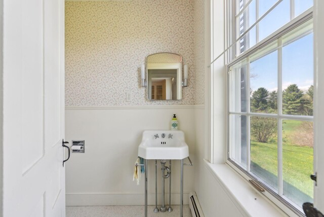 538 Malbons Mills Rd, Skowhegan, ME 04976 - bathroom featuring a wainscoted wall, wallpapered walls, a sink, and speckle patterned floor