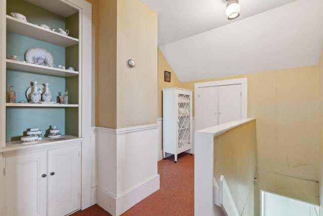 538 Malbons Mills Rd, Skowhegan, ME 04976 - corridor featuring built in features, vaulted ceiling, and carpet floors