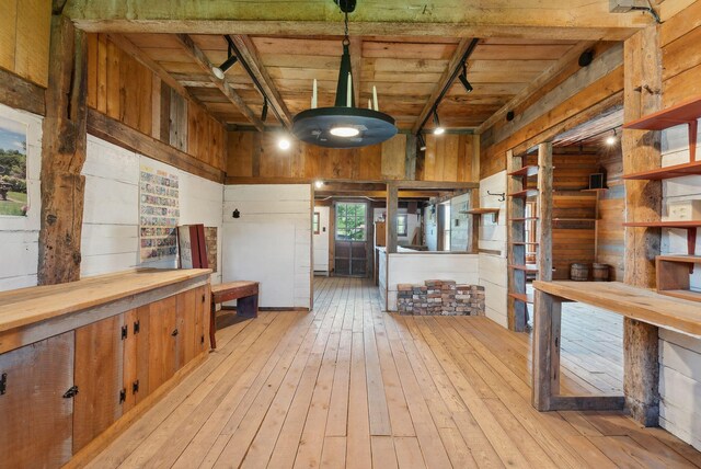 538 Malbons Mills Rd, Skowhegan, ME 04976 - misc room with wood walls, light wood finished floors, rail lighting, and wood ceiling