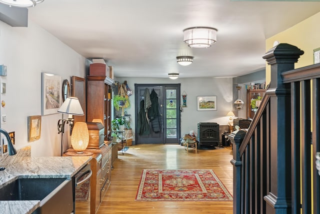 176 Second St, Auburn, ME 04210 - foyer featuring light wood-style floors and a wood stove