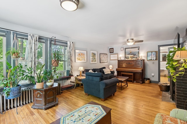 176 Second St, Auburn, ME 04210 - living room with light wood-style floors, ceiling fan, and radiator heating unit