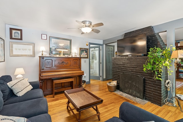 176 Second St, Auburn, ME 04210 - living area featuring a fireplace, ceiling fan, and wood finished floors