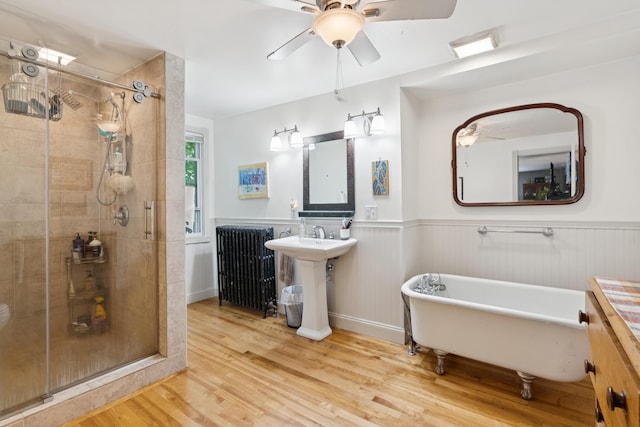 176 Second St, Auburn, ME 04210 - bathroom with wood finished floors, ceiling fan, a stall shower, a freestanding bath, and a wainscoted wall