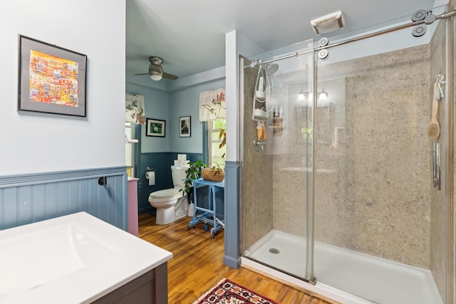 176 Second St, Auburn, ME 04210 - bathroom with vanity, a stall shower, a ceiling fan, a wainscoted wall, and wood finished floors