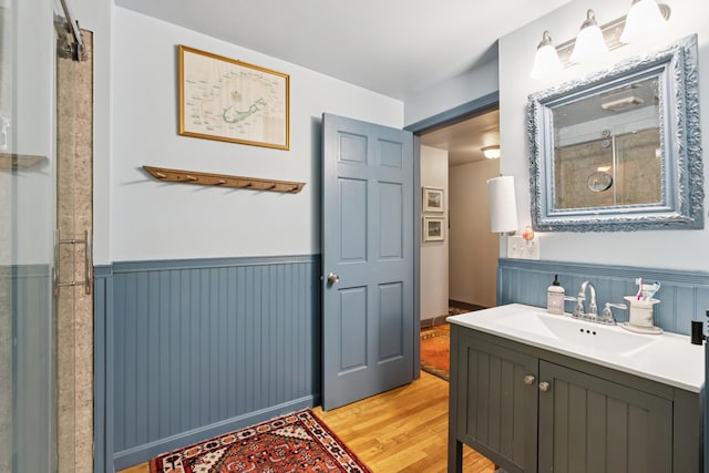 176 Second St, Auburn, ME 04210 - bathroom featuring wood finished floors, vanity, and wainscoting