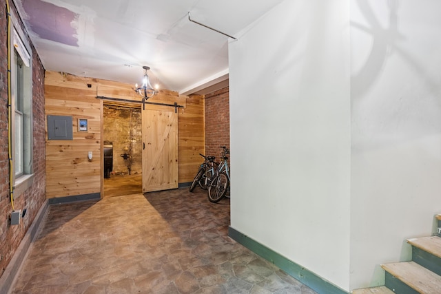 176 Second St, Auburn, ME 04210 - hallway with a barn door, wood walls, electric panel, stone finish flooring, and stairway