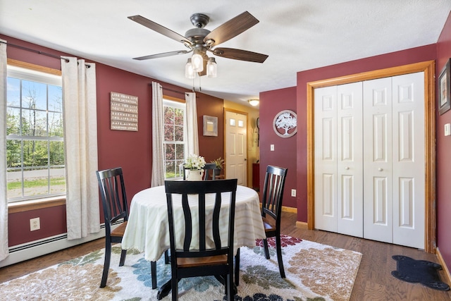 212 New Dam Rd, Waterboro, ME 04061 - dining area with a ceiling fan, wood finished floors, baseboards, and a baseboard heating unit