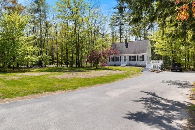 212 New Dam Rd, Waterboro, ME 04061 - cape cod home with driveway, a chimney, a front lawn, and a shingled roof