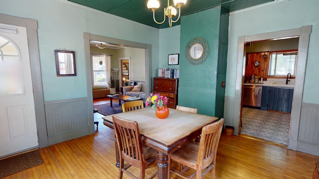 19 Russell St, Bangor, ME 04401 - dining space with light wood-type flooring, radiator, a chandelier, ornamental molding, and a wainscoted wall