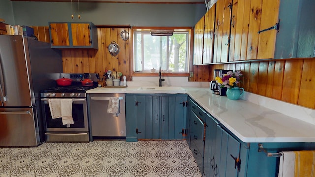 19 Russell St, Bangor, ME 04401 - kitchen featuring appliances with stainless steel finishes, a sink, blue cabinets, and light countertops