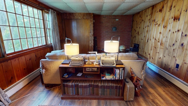 19 Russell St, Bangor, ME 04401 - living area with a baseboard radiator, wooden walls, and wood finished floors