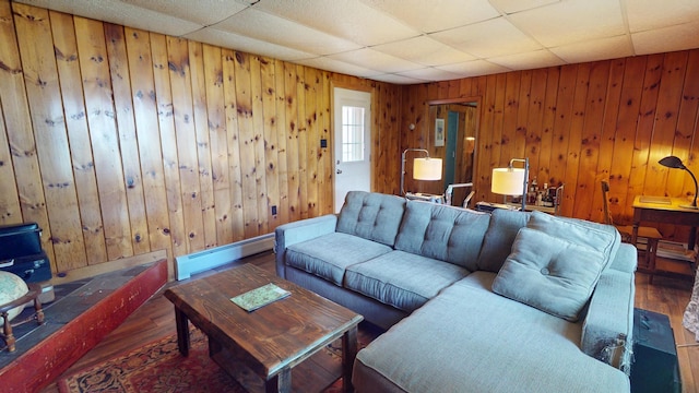 19 Russell St, Bangor, ME 04401 - living area featuring a baseboard radiator, wood finished floors, wood walls, and a drop ceiling