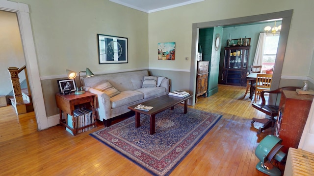 19 Russell St, Bangor, ME 04401 - living room featuring wood-type flooring, baseboards, ornamental molding, and a chandelier