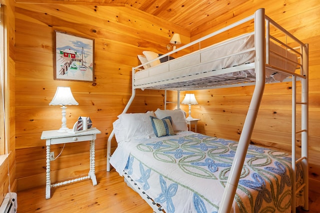 21 Linekin Rd, Boothbay Harbor, ME 04538 - bedroom with a baseboard heating unit, wood finished floors, and wooden walls