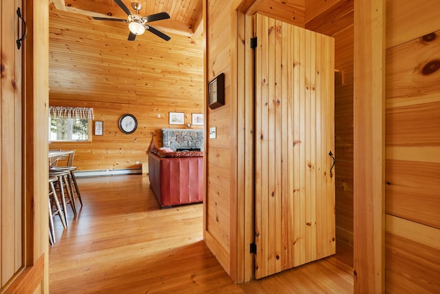 21 Linekin Rd, Boothbay Harbor, ME 04538 - corridor with wooden walls, baseboard heating, light wood-type flooring, wooden ceiling, and a sauna