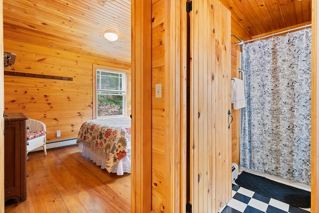 21 Linekin Rd, Boothbay Harbor, ME 04538 - bedroom featuring wood walls, wood ceiling, a baseboard heating unit, and hardwood / wood-style floors