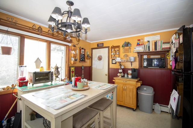 dining space featuring a chandelier, crown molding, light tile patterned flooring, and a baseboard radiator
