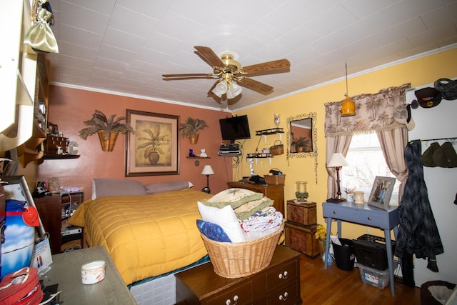 bedroom featuring ornamental molding and wood finished floors