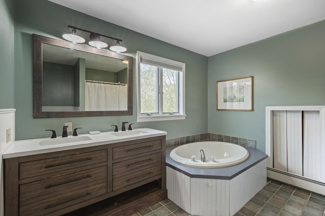 17 Westview Rd, Damariscotta, ME 04543 - full bath featuring a baseboard heating unit, double vanity, and a garden tub